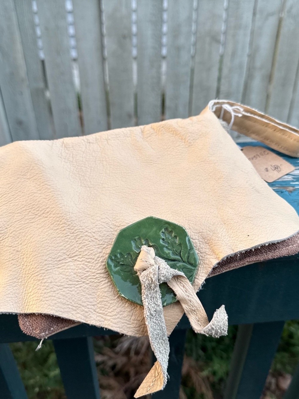Handmade Cream Leather Wrist Pouch with Green Leaf Medallion
